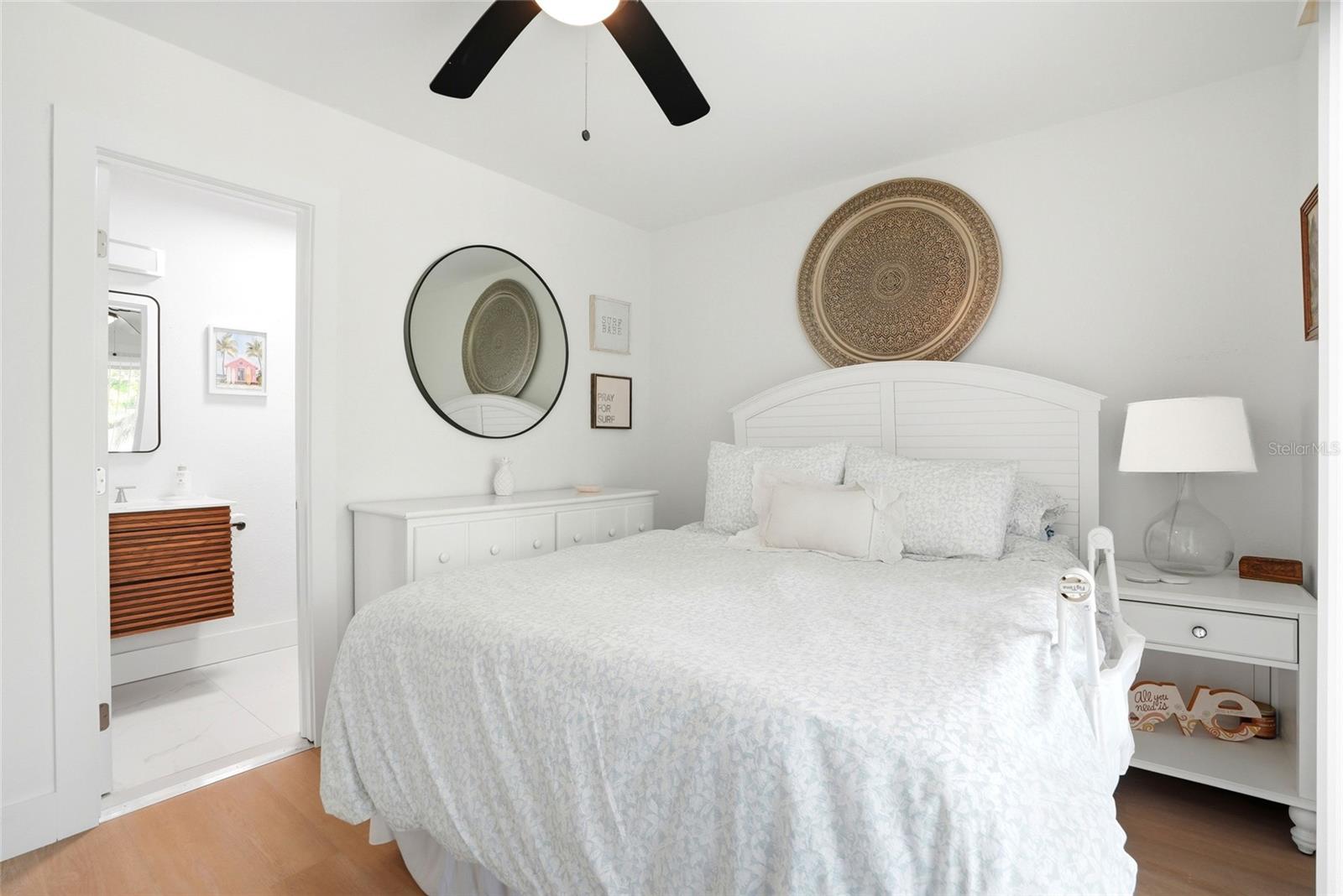 Spacious primary bedroom with ceiling fan