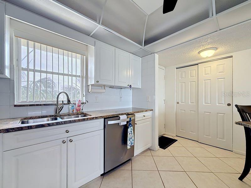 Modern coastal charm kitchen with tile floors, sleek finishes, and a layout that flows endlessly for entertaining.