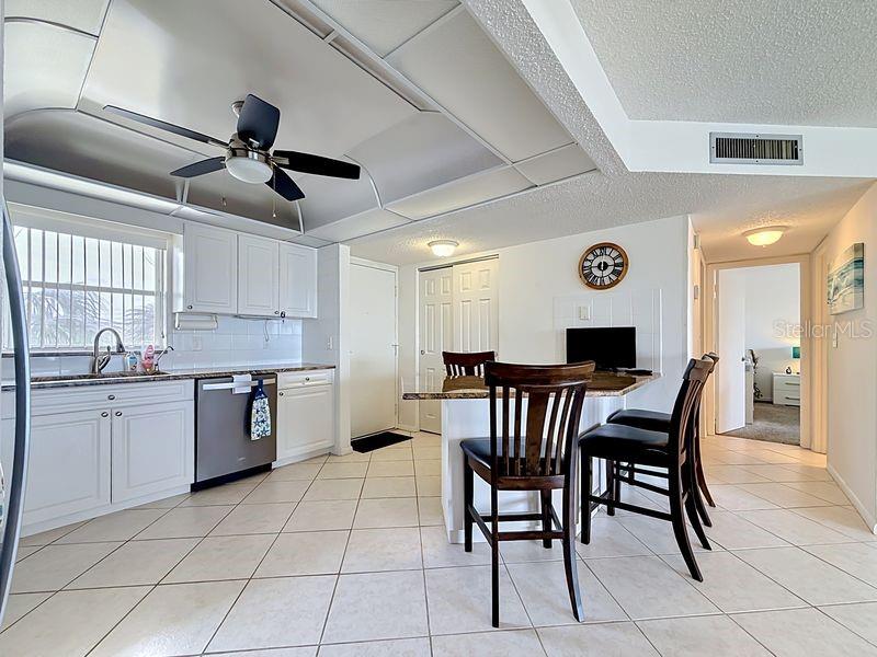 Modern coastal charm kitchen with tile floors, sleek finishes, and a layout that flows endlessly for entertaining.