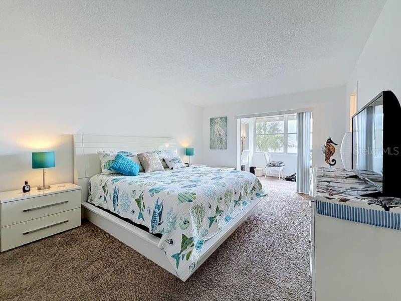 Peaceful Primary Suite with an abundance of natural light, soothing coastal tones, and space to unwind after a long day