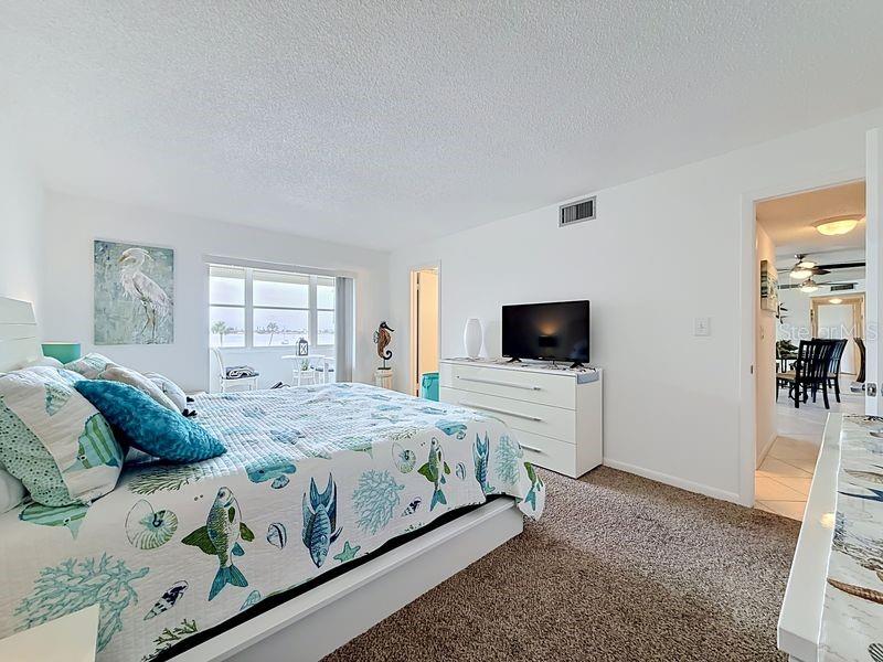 Peaceful Primary Suite with an abundance of natural light, soothing coastal tones, and space to unwind after a long day