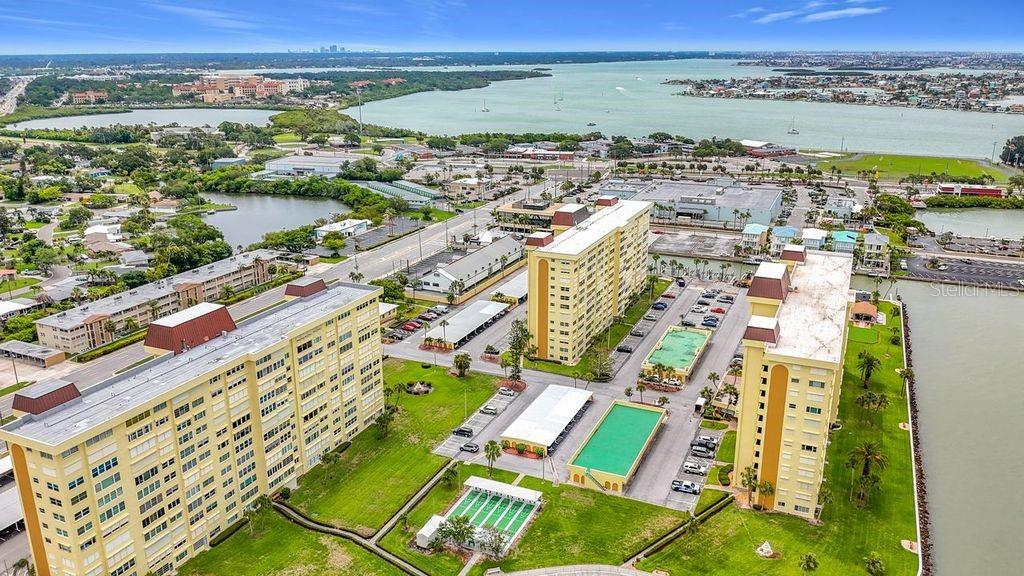 Resort-style community view featuring the Washington building, tennis and pickleball courts, and sparkling pool- all nestled around the tranquil bayou