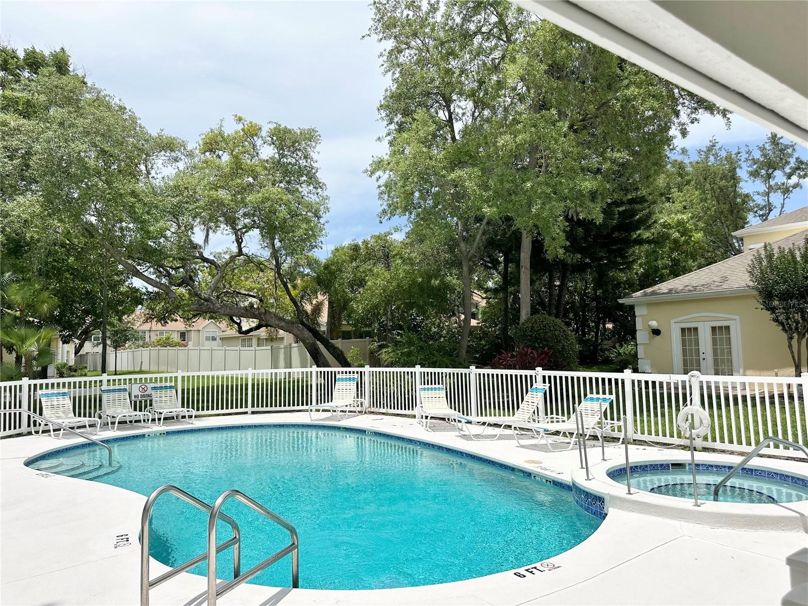 fenced pool/hot tub area
