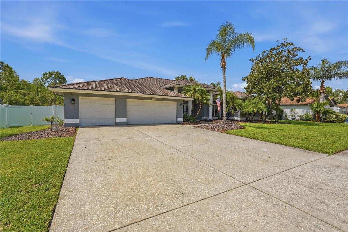 Spacious oversize three car garage with EV charger