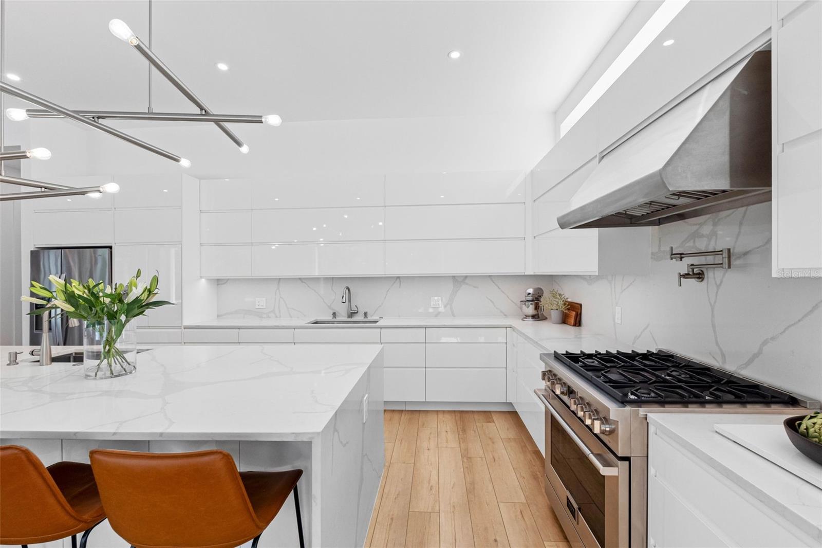 Custom kitchen boasts solid drawer cabinetry system for functionality, Bloom soft closure hinges, cabinet to store everyday appliances, 2 sinks with disposal, 6 burner 36" Fulgor Milano, professional hood among other features.