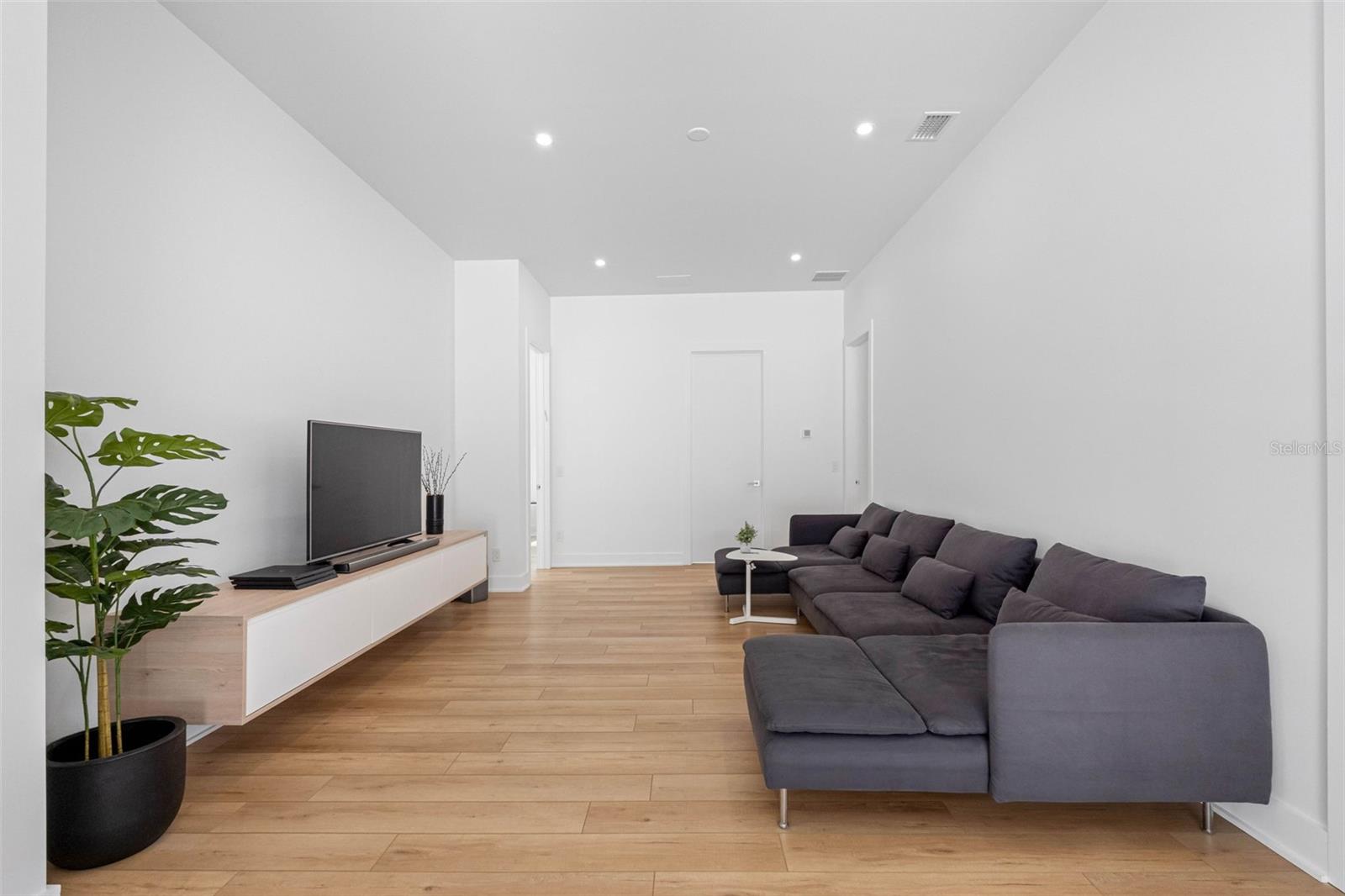 Family room on the second floor features built-ins to store media devices and drawers. Dimmable lights.