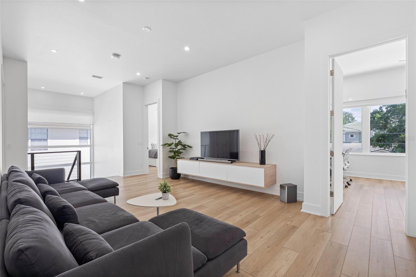 Family room on the second floor features built-ins to store media devices and drawers. Dimmable lights.