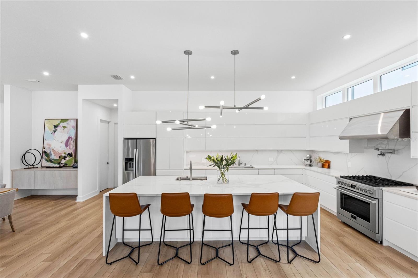 Custom kitchen boasts solid drawer cabinetry system for functionality, Bloom soft closure hinges, cabinet to store everyday appliances, 2 sinks with disposal, 6 burner 36" Fulgor Milano, professional hood among other features.