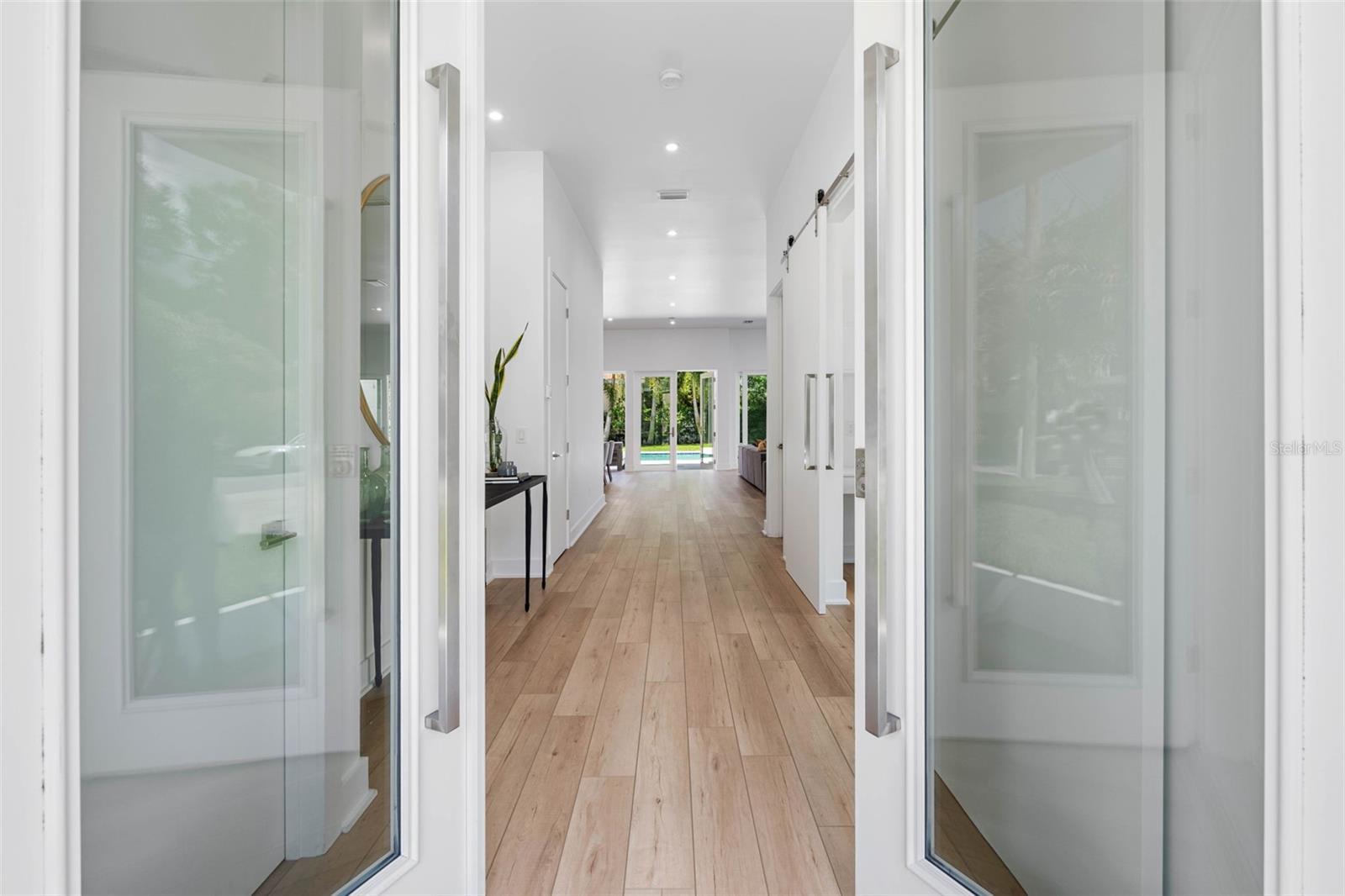 French glass doors welcome you into an impressive foyer