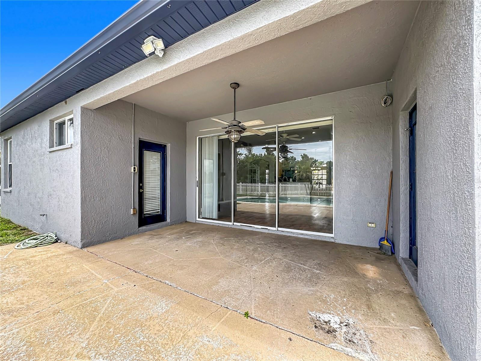 Triple sliding doors accented with a french door to the hall bath on the left and a french door on the right leads to the primary bedroom