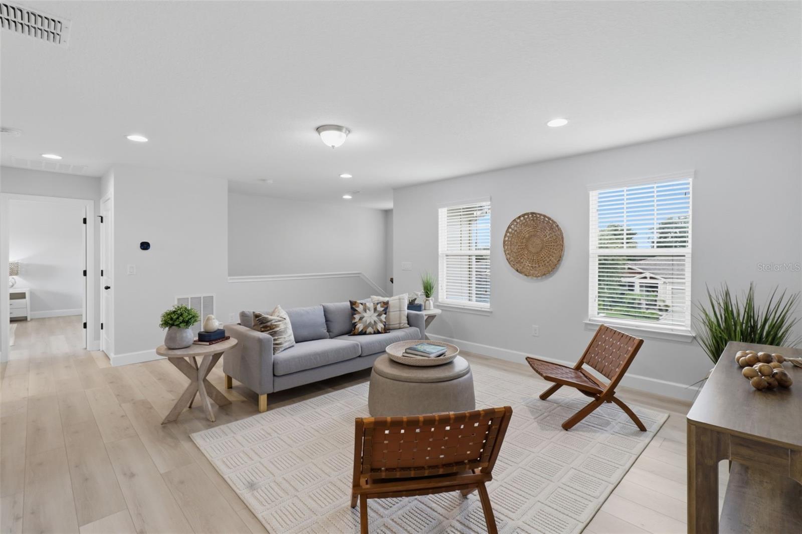 The second-floor loft offers endless possibilities as a home office, media room, playroom, or additional living area.