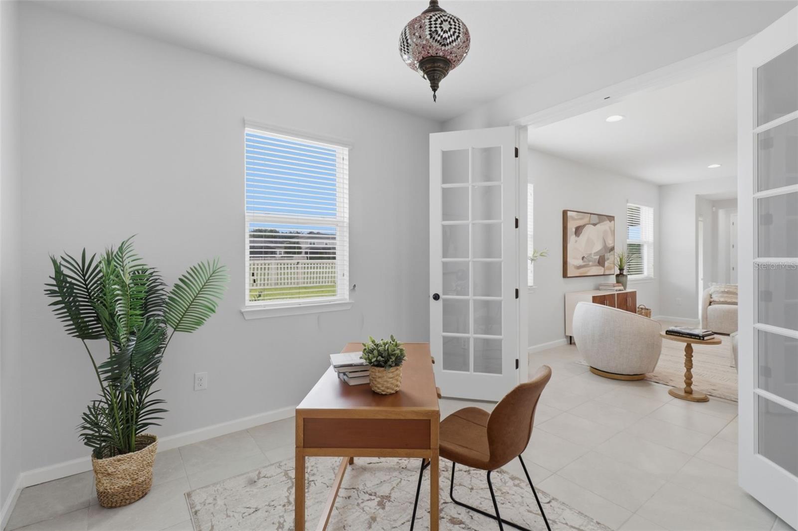 French-door entry to a flexible office/den space, perfect for working from home or relaxing in privacy.