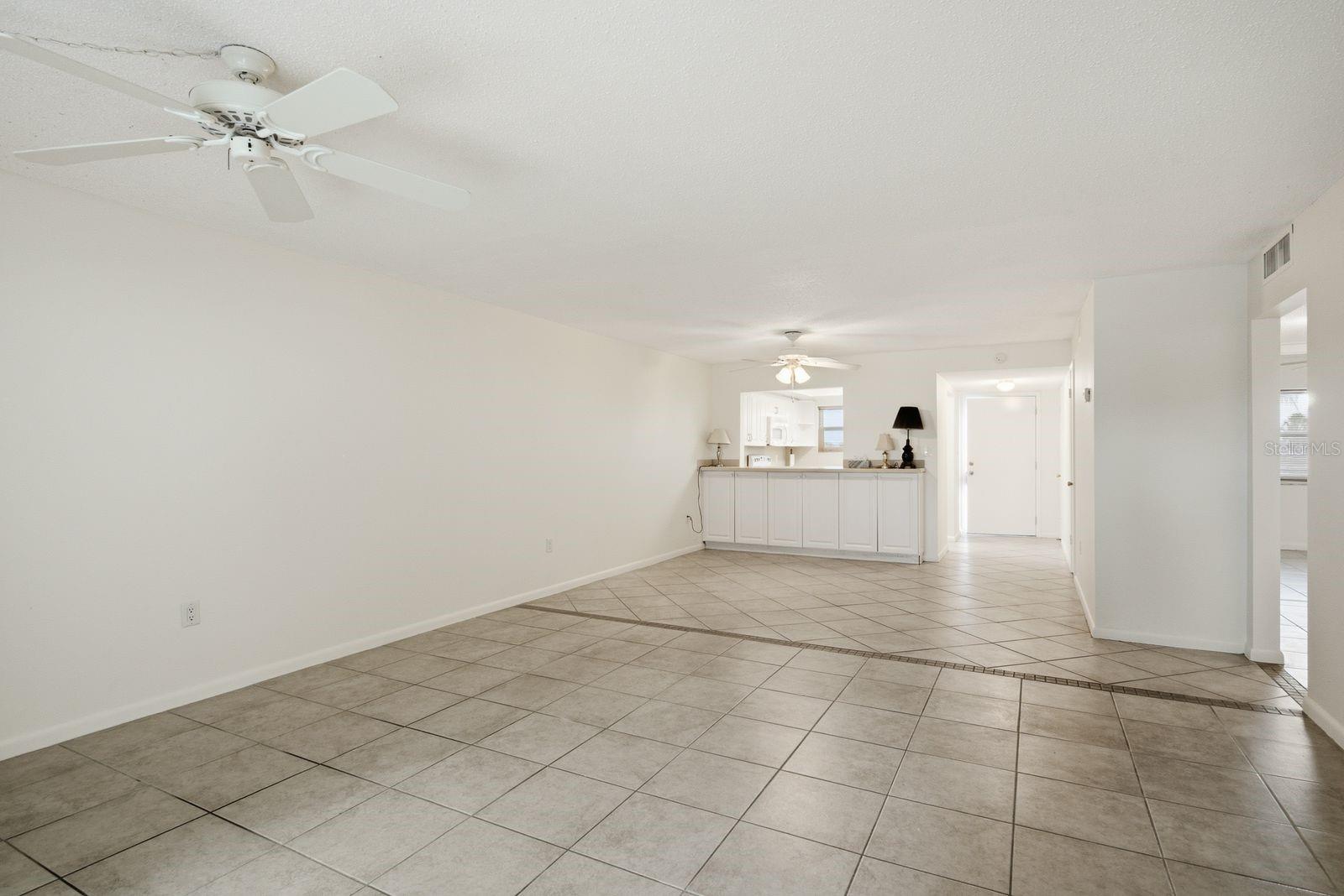 From Living room to Dining Area, Kitchen and front door.