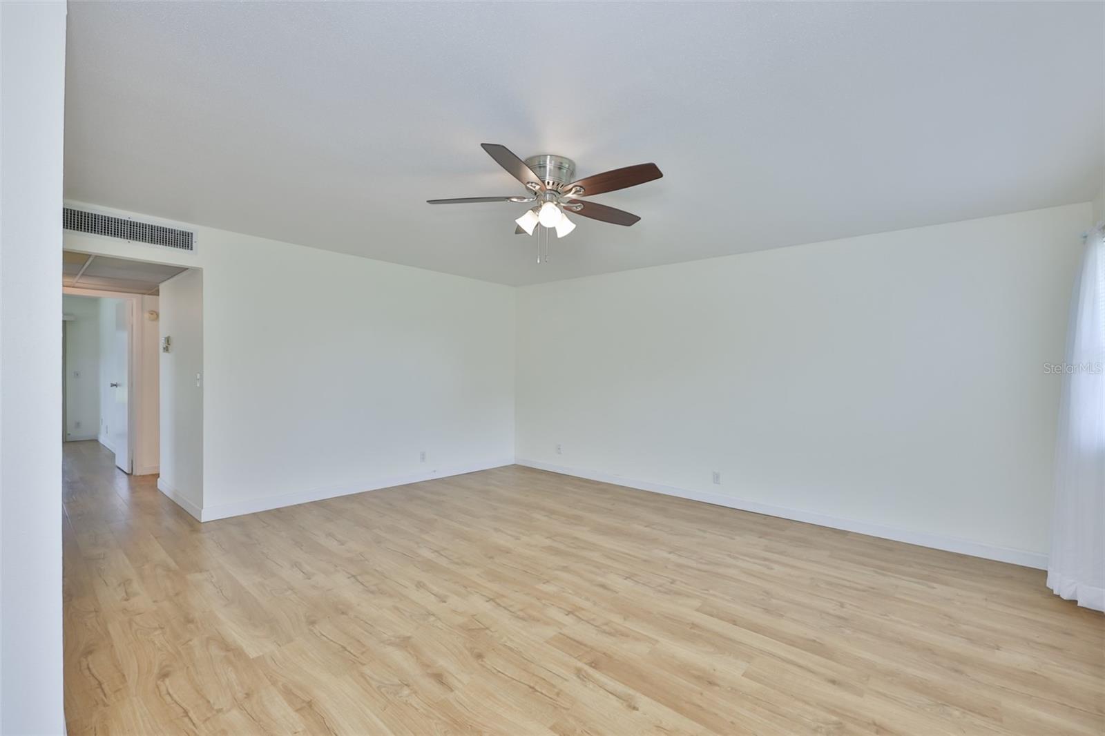 The room is large with lots of wall space for furniture and decor.