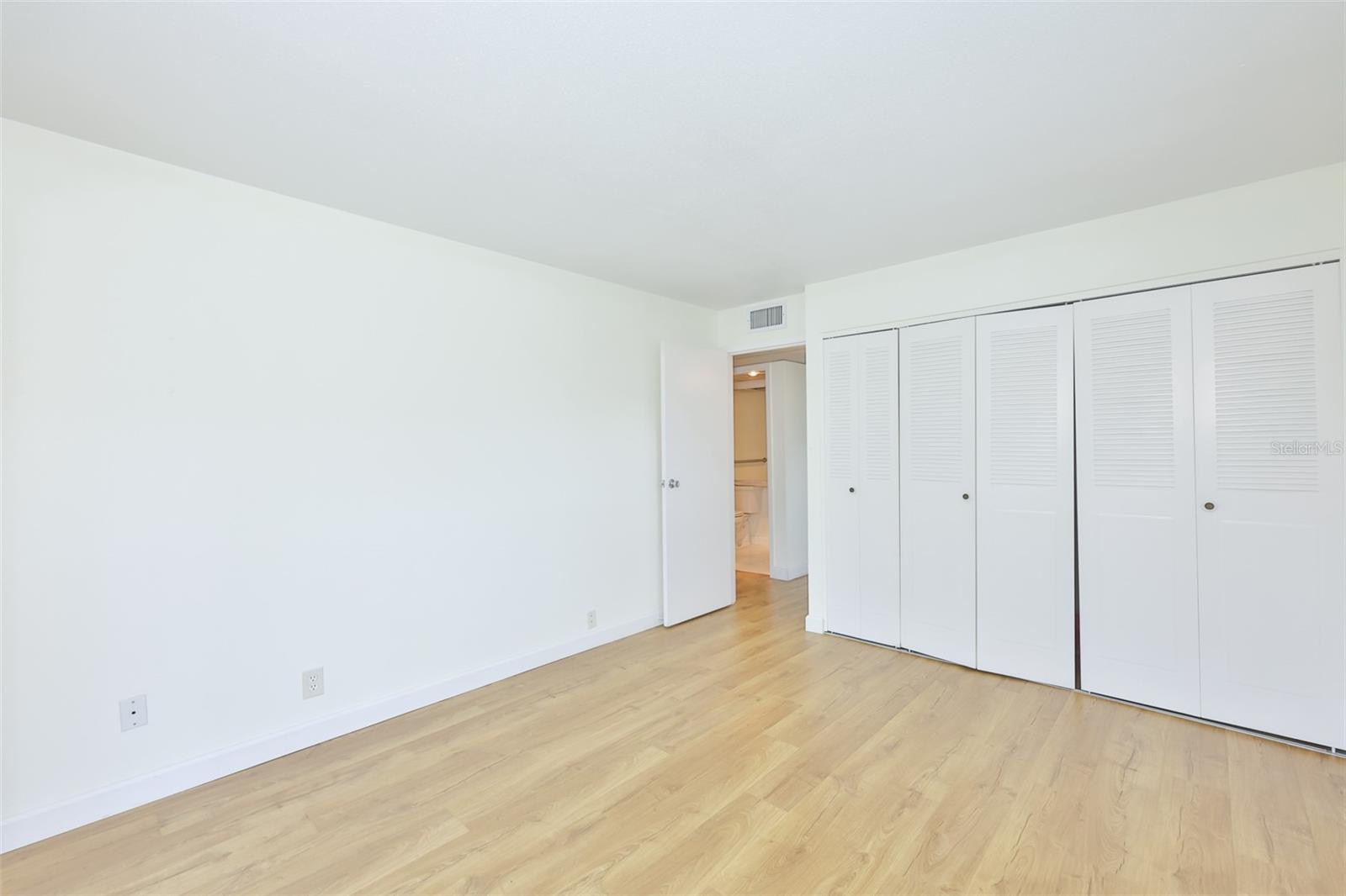 A whole wall of closet space is perfect for storage.
