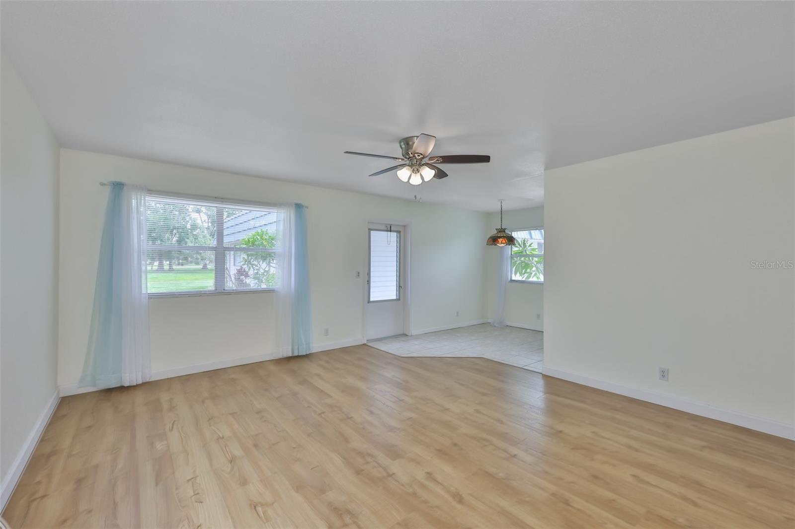 Living room is large with laminate flooring.