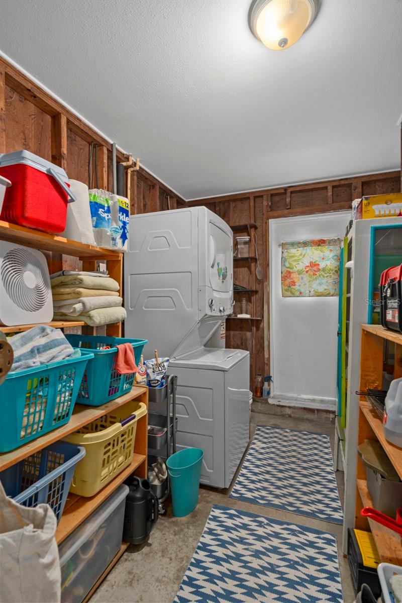 Utility Room features stackable washer & dryer as well as storage, the air handler and hot water heater.