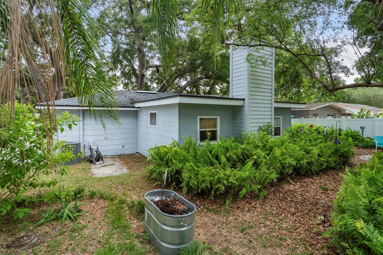 Rear exterior of home and easy care backyard