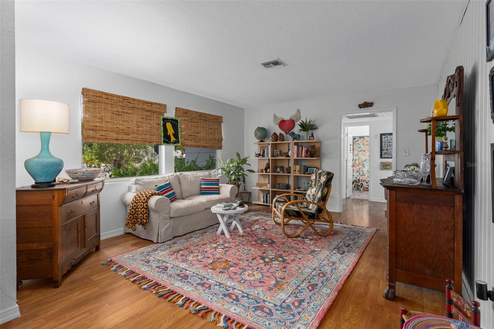 Main living room at front of the house.  Secondary bedrooms and bath through just beyond