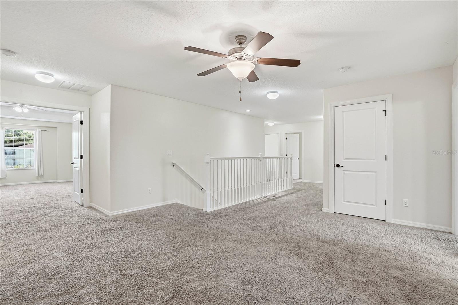 Entrance to the primary suite on the left from the loft space