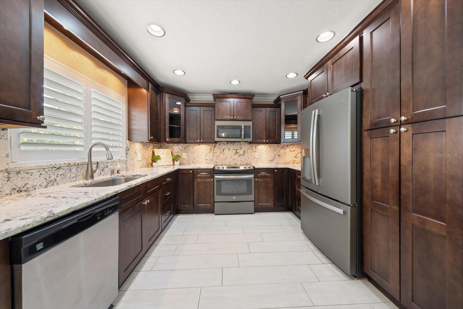 Fully equipped kitchen with custom cabinetry and very attractive granite counters and backsplash!