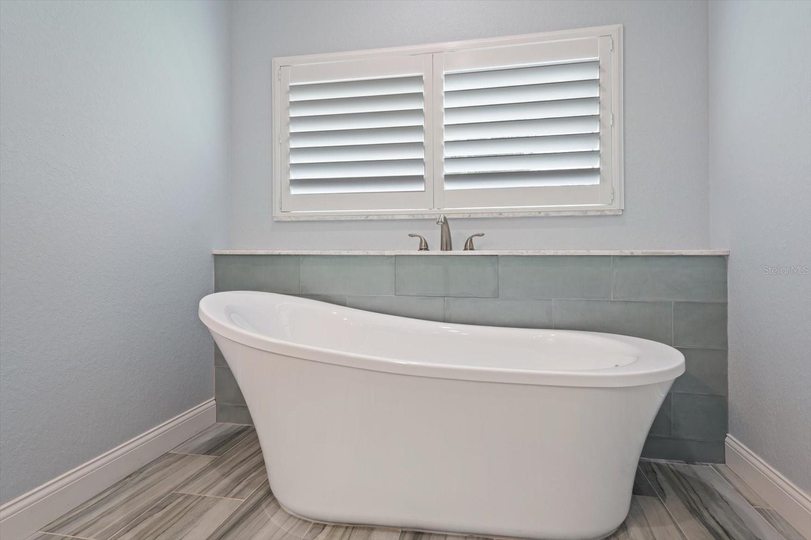 Enjoy soaking in the tub in the primary bath retreat!