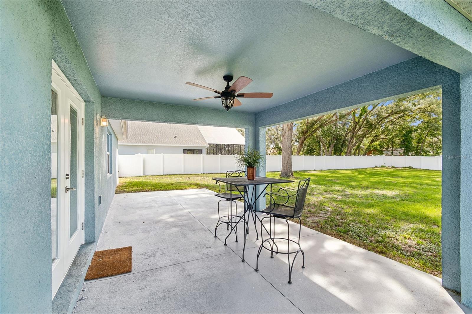 Covered Patio and cleared backyard on extra lot surrounded by privacy fence.