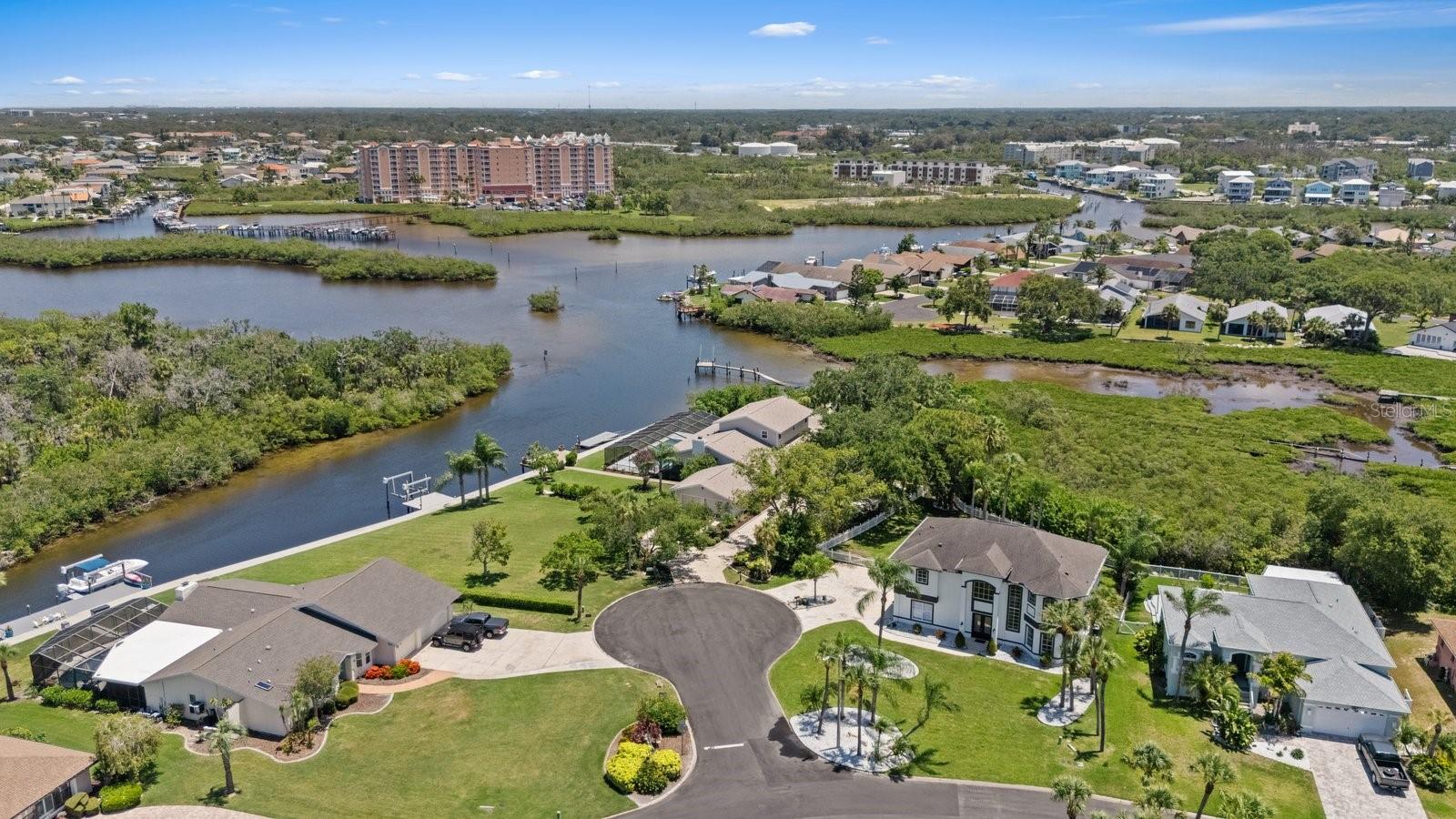 Aerial of cul-de-sac property with wide canal views