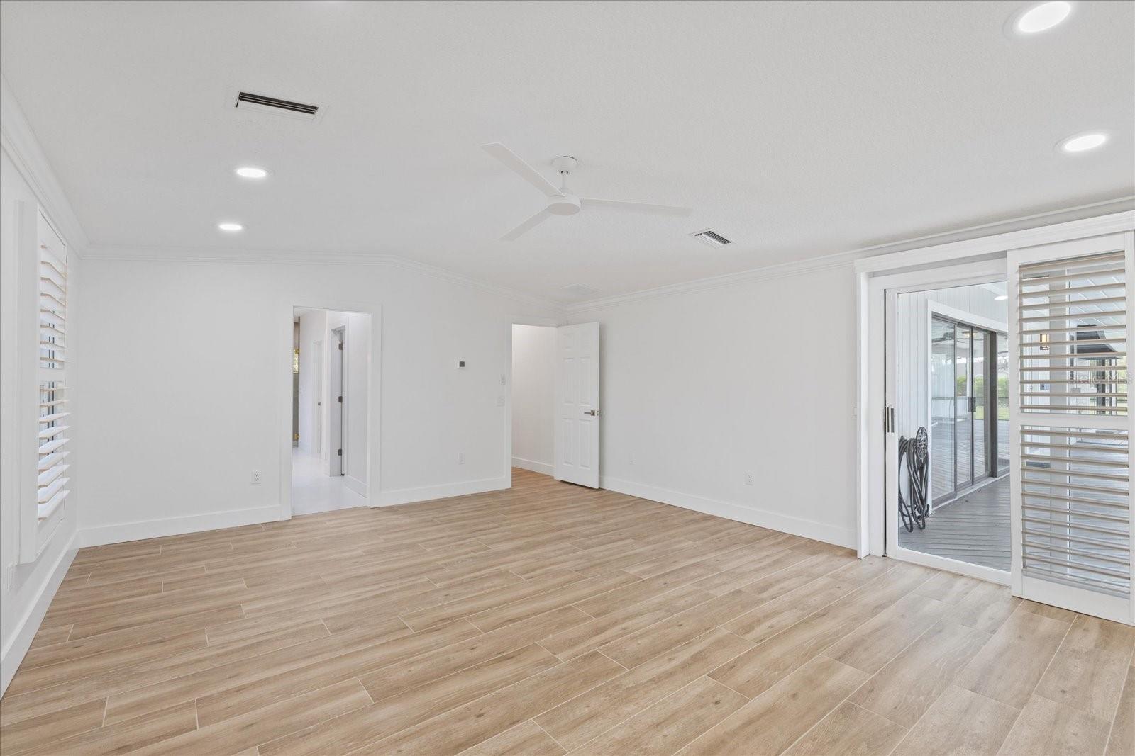 Large Primary ensuite with sliders to pool and outdoor kitchen/covered patio area.