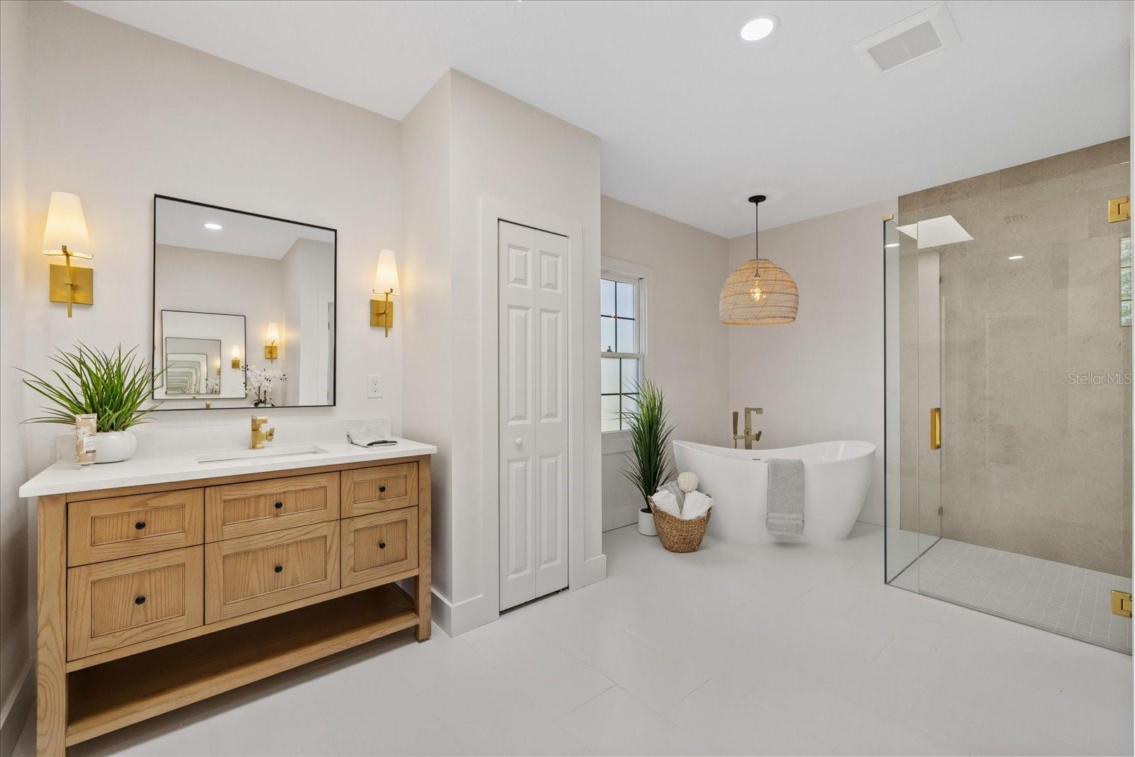 Primary en-suite bath with luxury tub and grand shower.