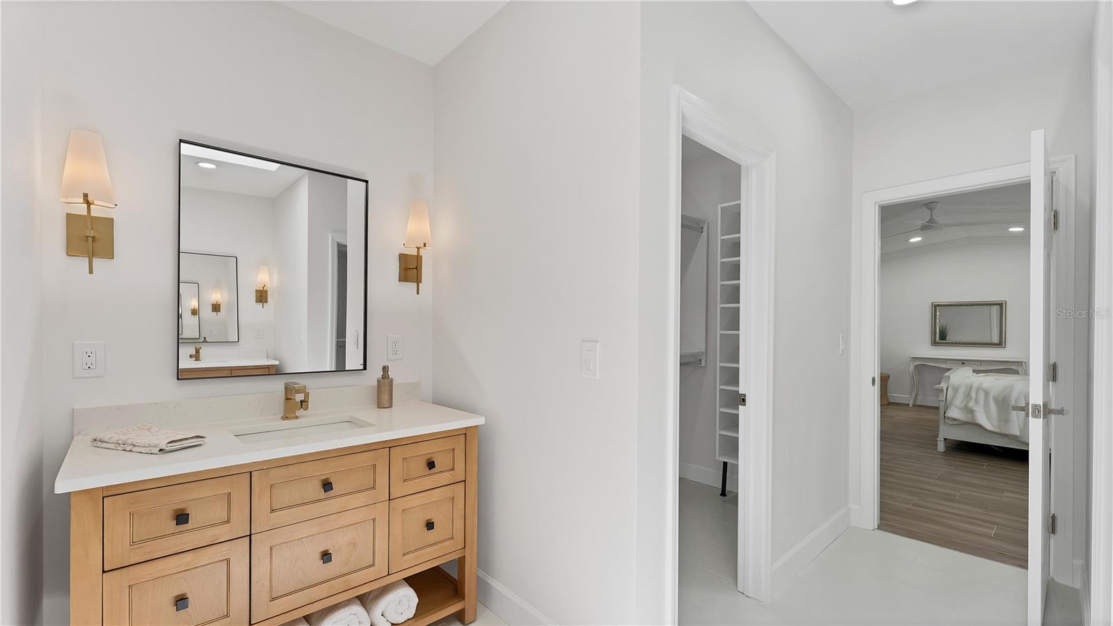 Primary ensuite bath with two walk in closets and two vanities