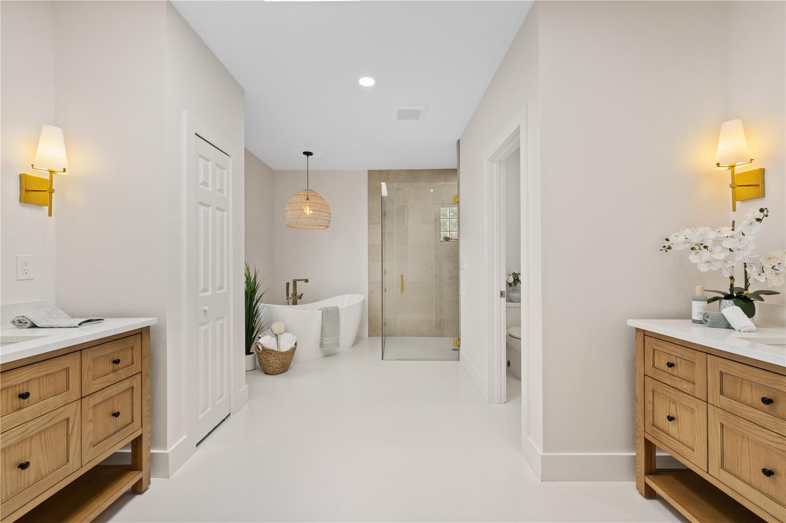 Primary ensuite bathroom with two individual vanity sinks.
