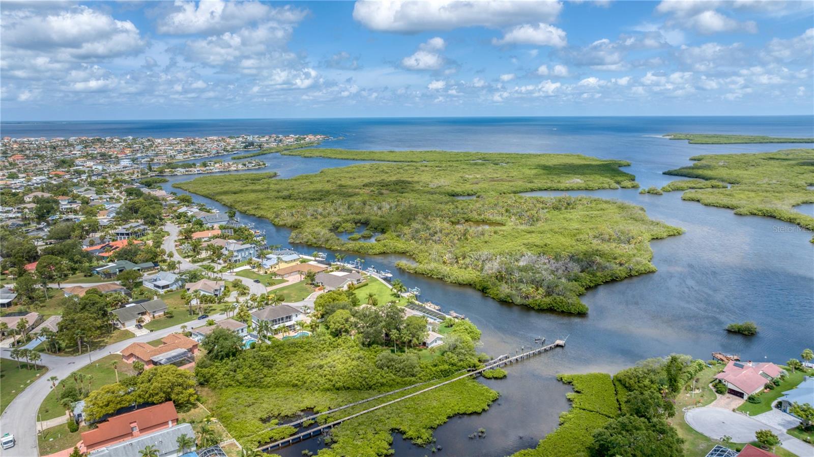 Aerial view of property looking West towards Gulf with deep channel access