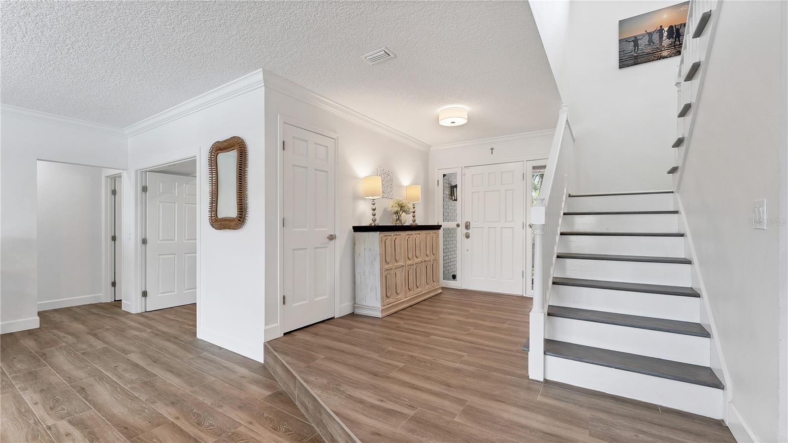 Front entryway with staircase to 2nd level (Previously staged)