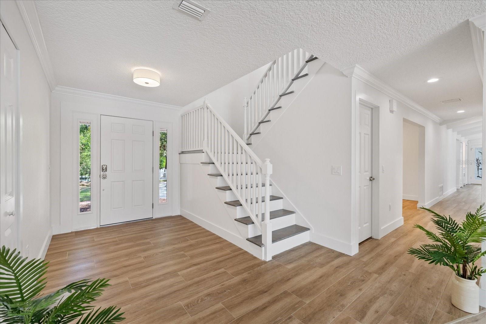 Entry looking down hallway to kitchen, dining and living room
