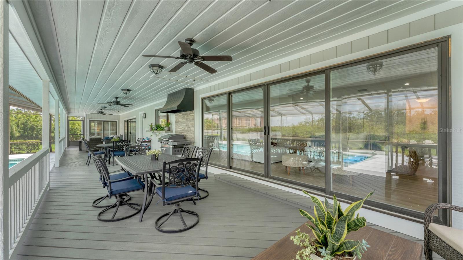 Outdoor back patio and gas grill with hood (previously staged)
