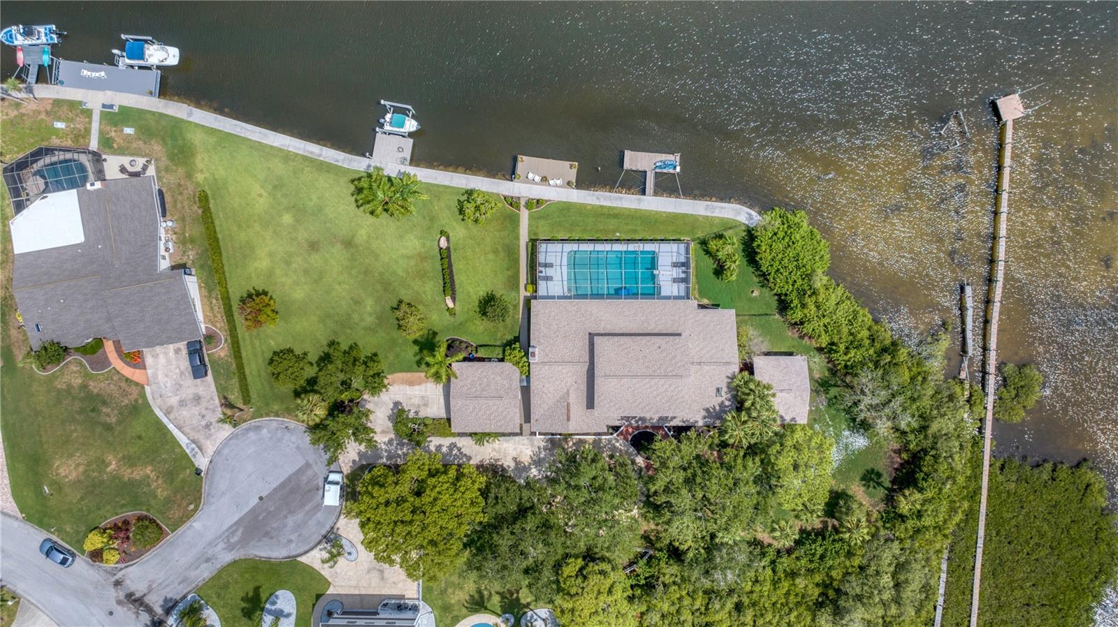 Aerial view of pool home with stationary and floating dock