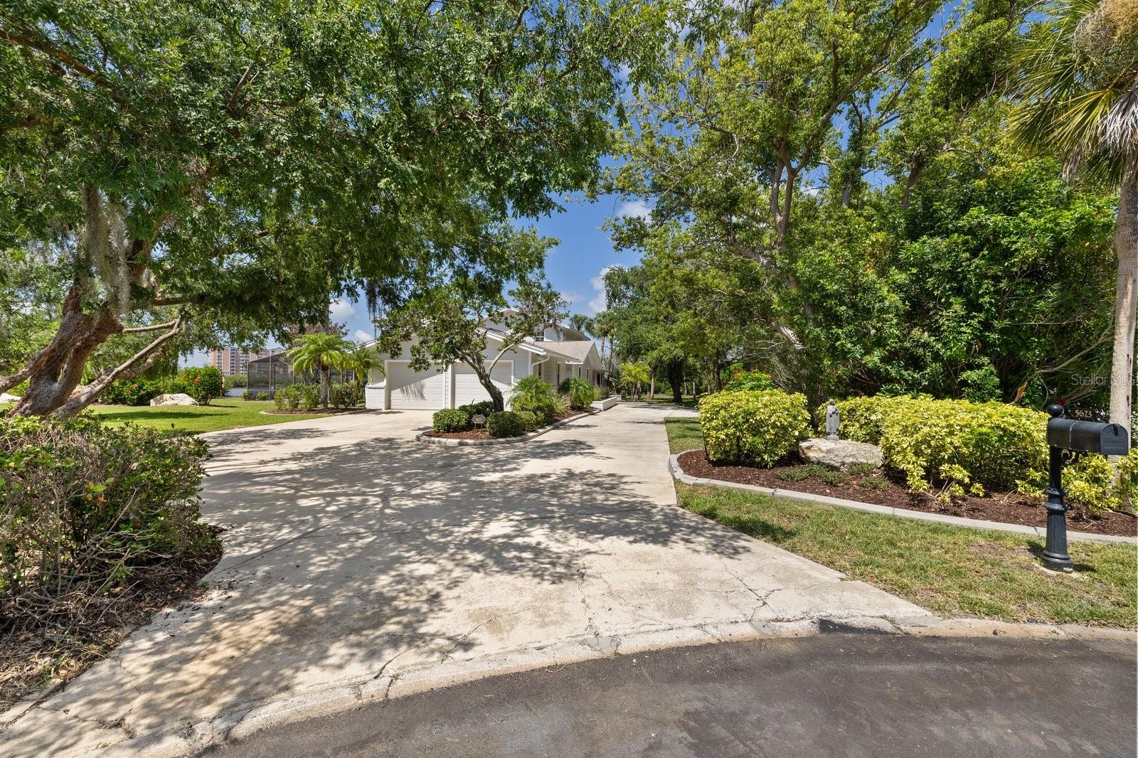 Long driveway with parking and circle driveway and garage