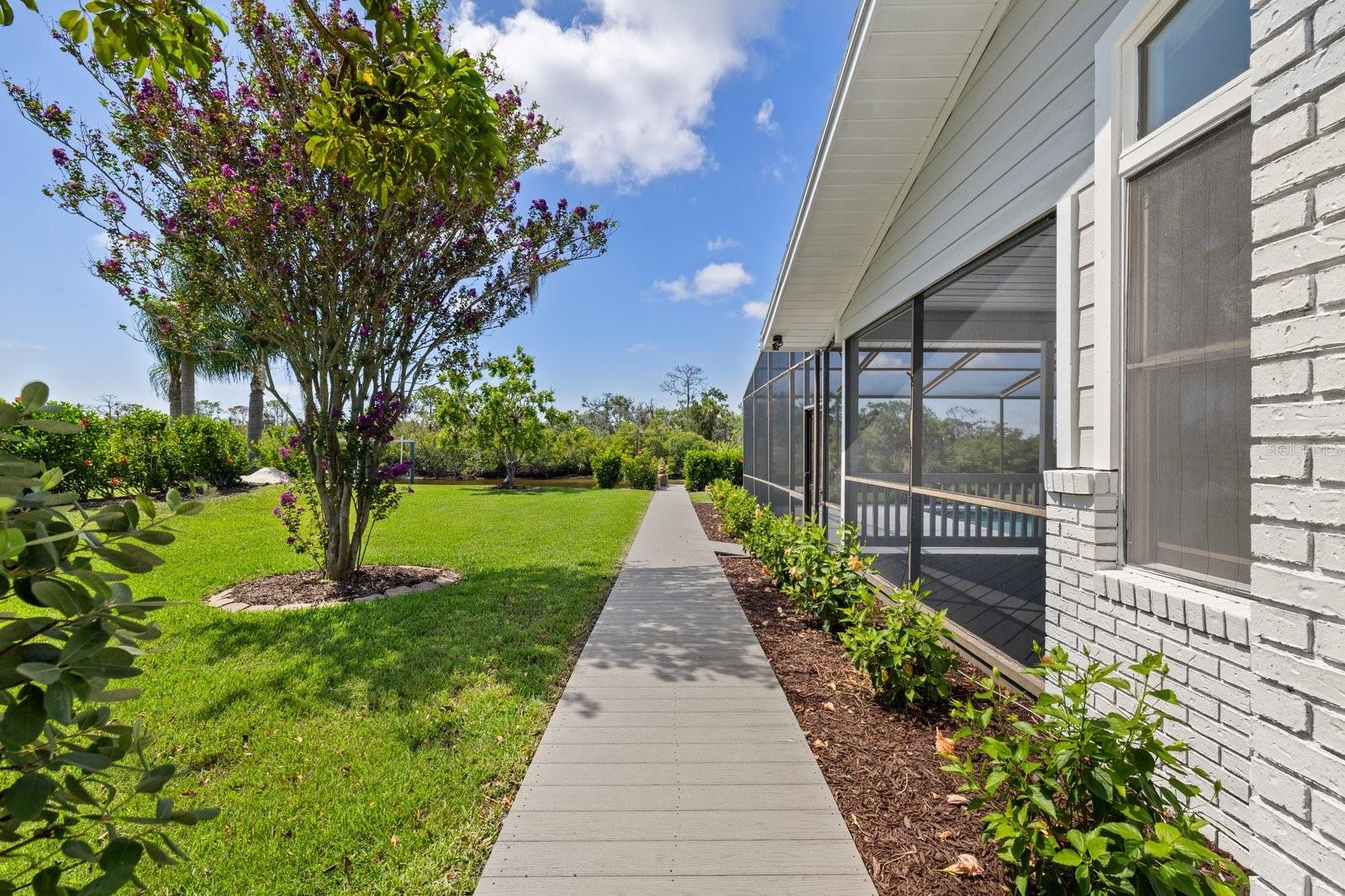 Walkway to Docks from between home and garage near pool.