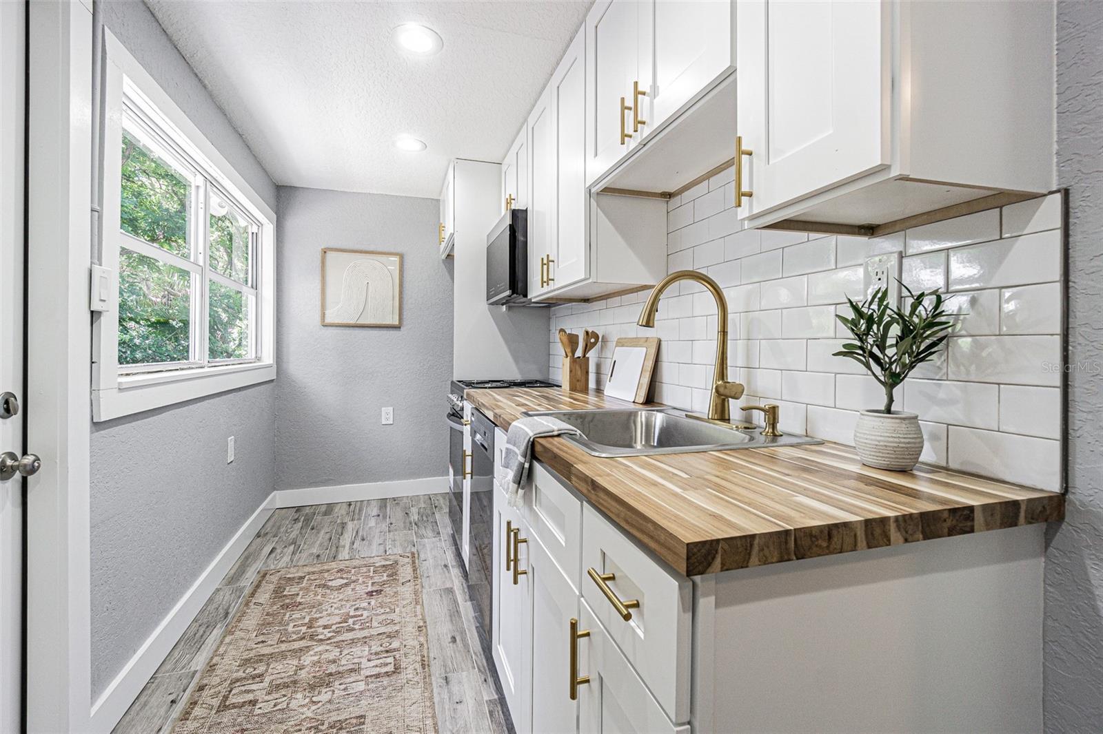 And then the Galley Style Kitchen tucked away with subway tile mixed metal accents, stainless steel appliances plus will steel your heart away!