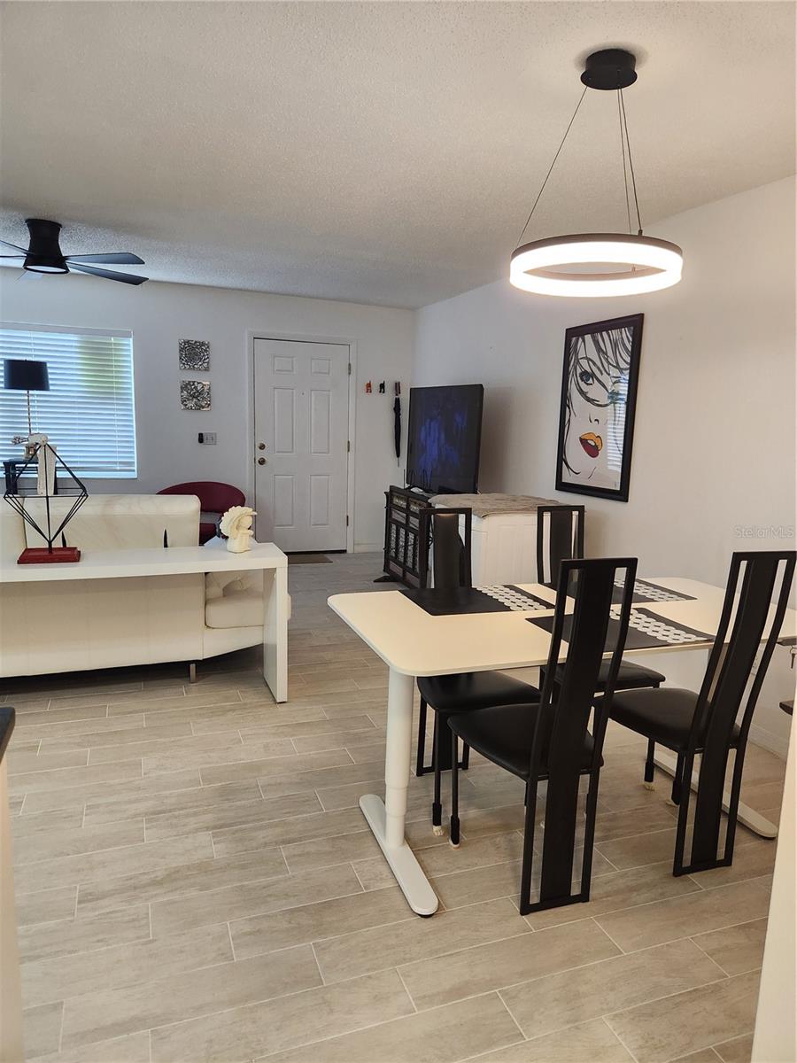 Open concept dining room, living room & kitchen with new tile floors throughout