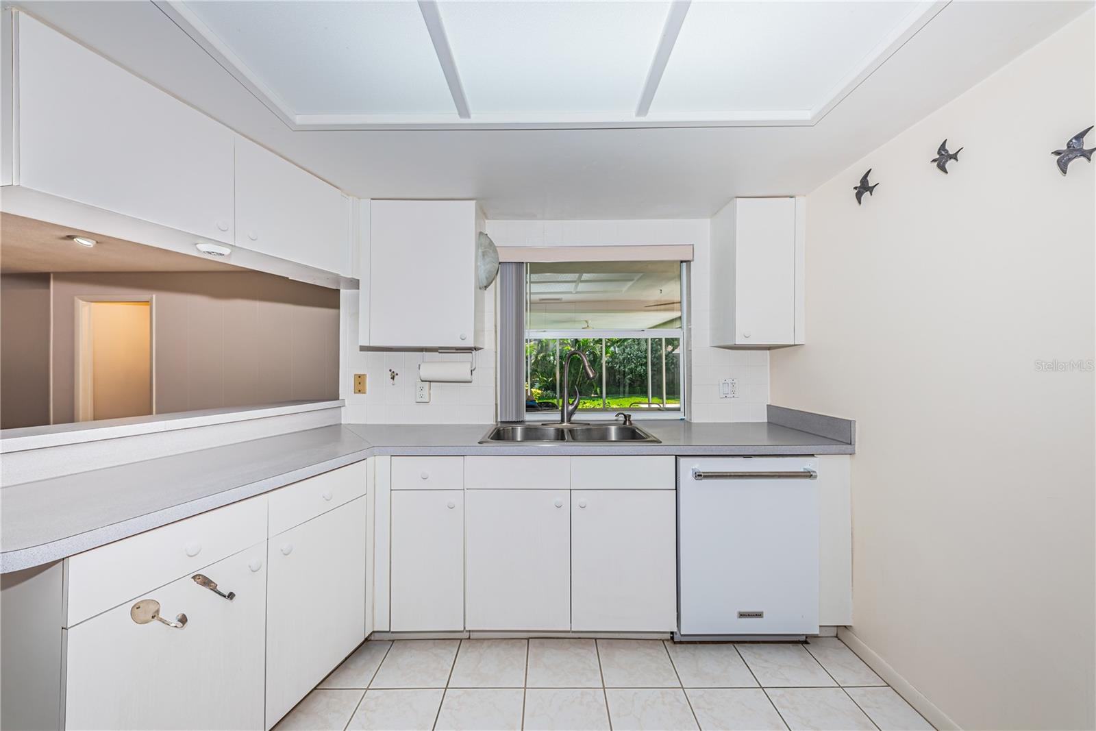 Kitchen overlooks the lush backyard
