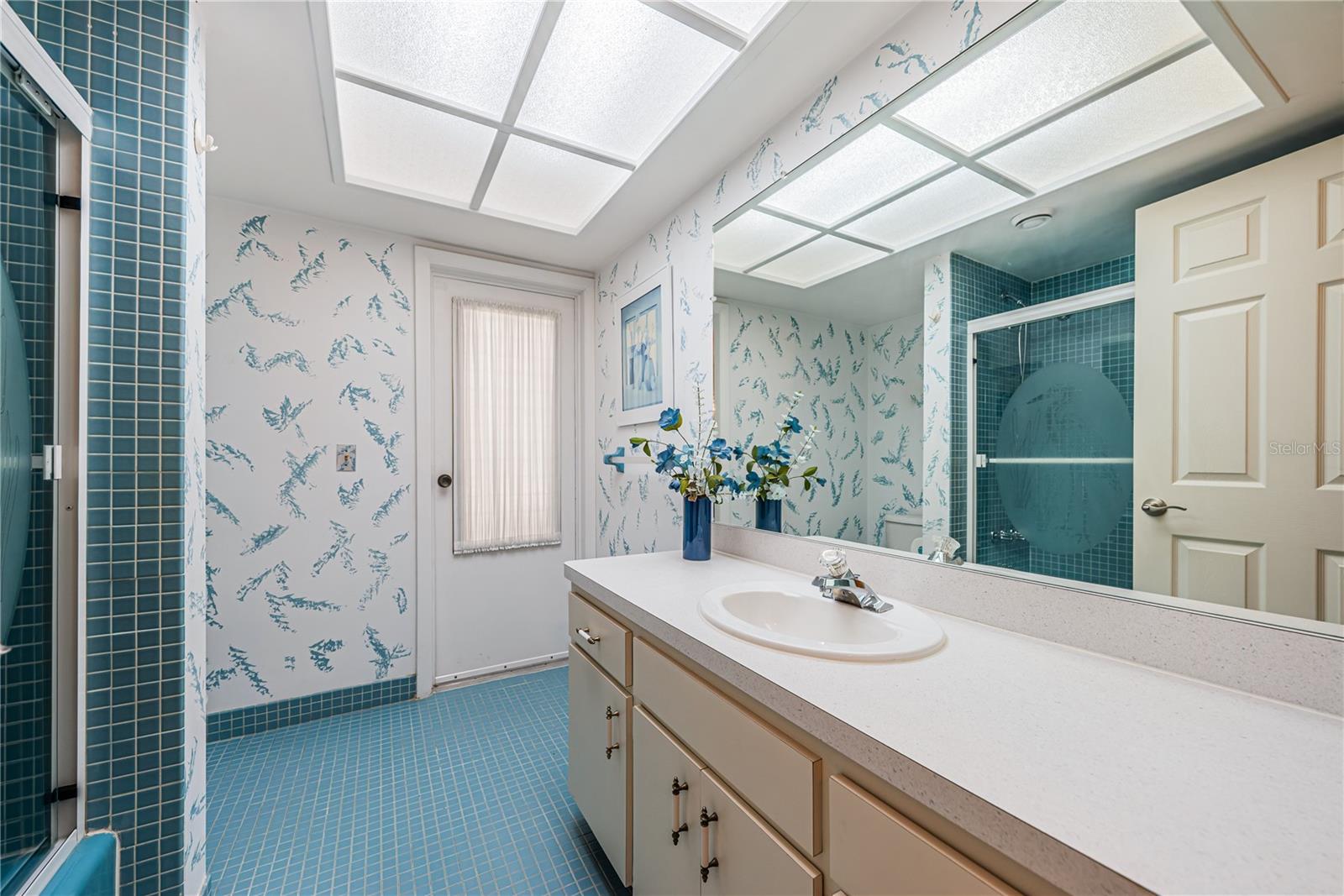 Large 2nd bath has door to enter lanai and pool area