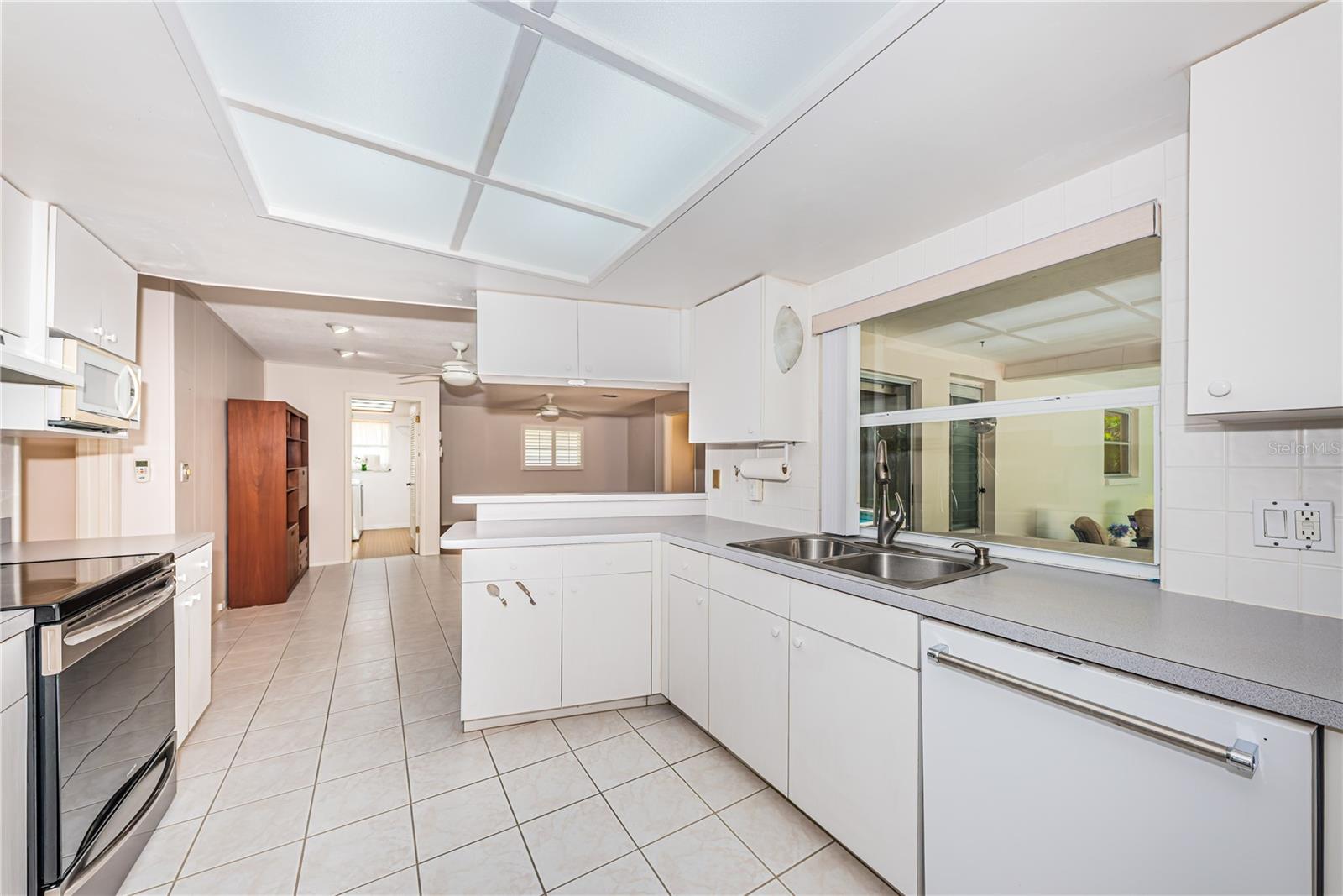 Spacious kitchen overlooking lanai and pool area