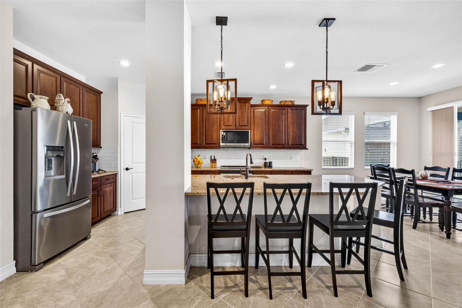Your kitchen has classic wood cabinetry crowned & overhead light fixtures added.
