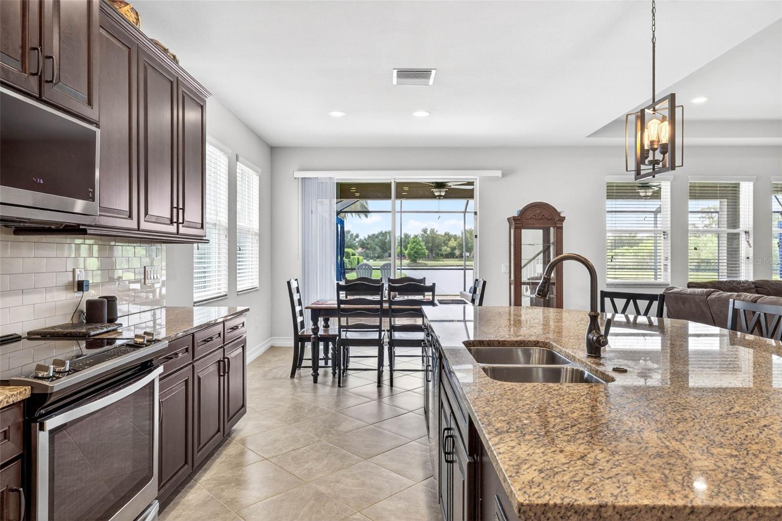 Stainless steel appliances & a view toward the dining area.