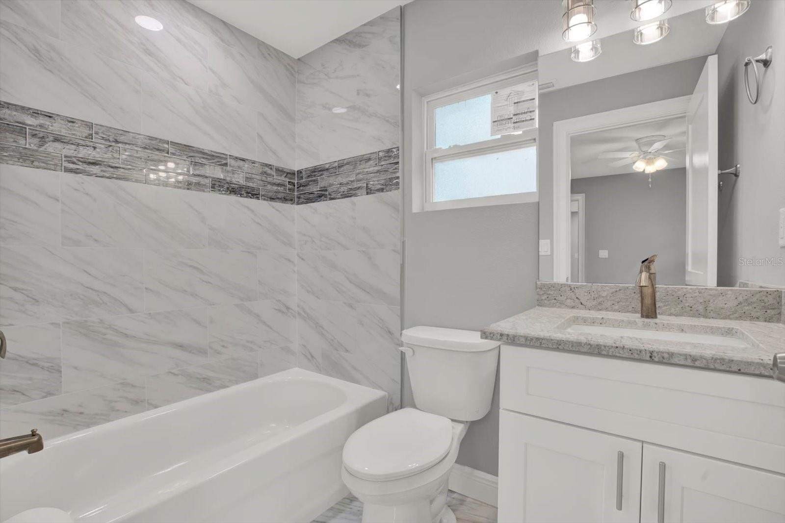 En Suite bath with beautiful decorative Inset Tiled Banner