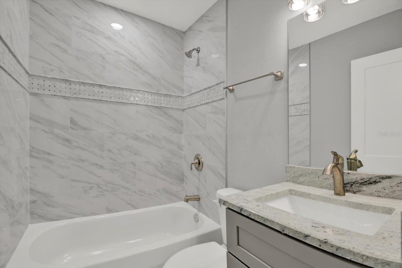 Shared Second Bath with decorative inset beaded tile