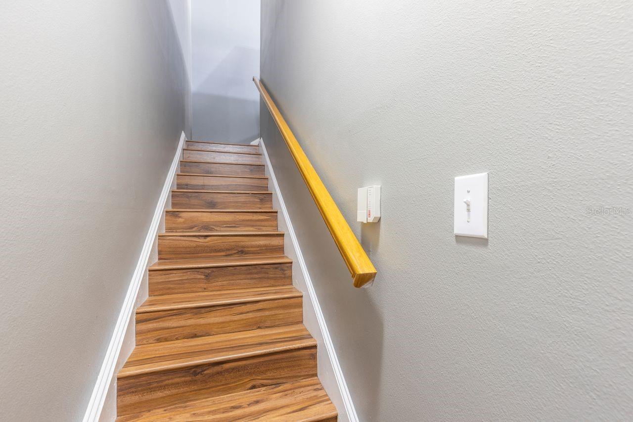 Interior stairwell with direct access to the garage for added security and seamless accessibility.