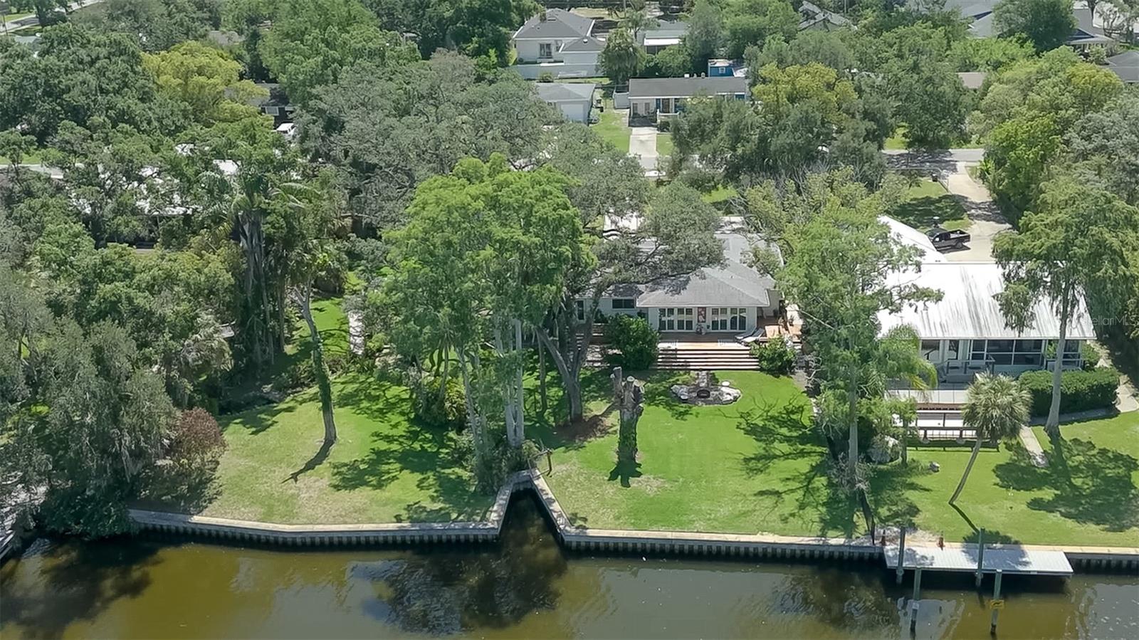 This park like property includes; 140 feet of engineered sea wall, .65 of an acre of picturesque lawns, a manicured spring, multiple fruit trees and palm trees